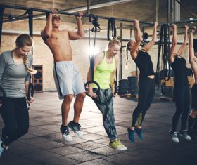Men and women exercising in the gym Stock Photo