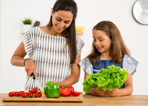 Mom teach her daughter cutting vegetables in the kitchen Stock Photo 04