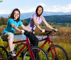Mother and daughter riding bicycle Stock Photo