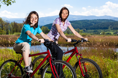 Mother and daughter riding bicycle Stock Photo