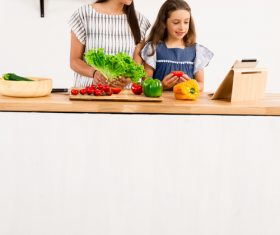 Mother and daughter watch video learn how to cook Stock Photo 03