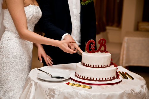 Newlyweds cut cake Stock Photo