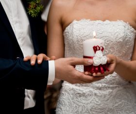 Newlyweds holding candles in hand Stock Photo