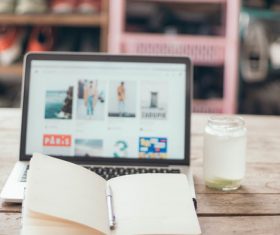 Notepad and laptop on desktop Stock Photo