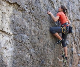 Outdoor woman unarmed rock climbing Stock Photo 02