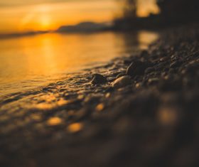 Pebbles on the beach at sunset Stock Photo
