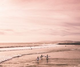 People joyful on beach at dusk Stock Photo