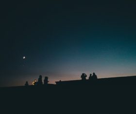 People watching moonlight in dark night Stock Photo