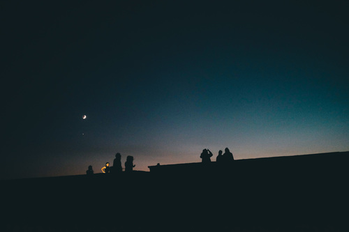 People watching moonlight in dark night Stock Photo