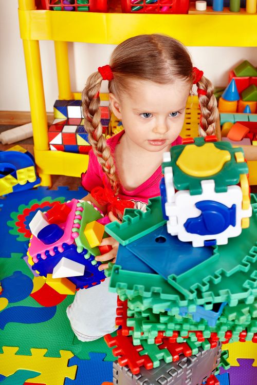 Playing with building block little girl Stock Photo