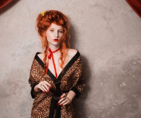 Red haired girl holding glasses in hand Stock Photo