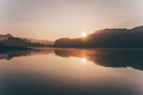Reflection of dusk scenery on calm lake Stock Photo