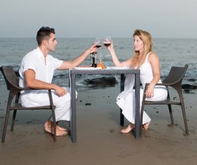 Romantic couple dining by the sea Stock Photo