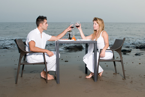 Romantic couple dining by the sea Stock Photo