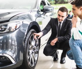 Salesperson introducing new car performance Stock Photo