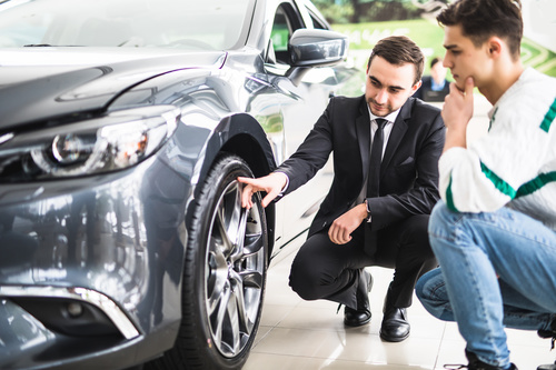 Salesperson introducing new car performance Stock Photo
