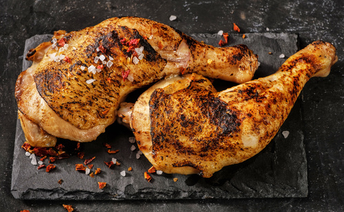 Salt pepper and roasted chicken legs Stock Photo