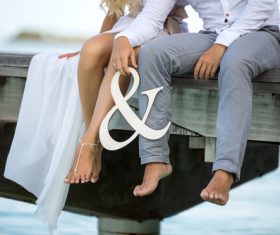 Sitting on wooden bridge legs closeup Stock Photo