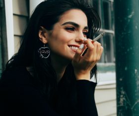 Smiling smoking woman Stock Photo