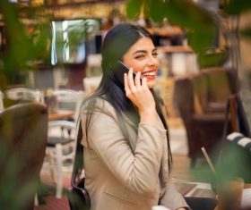 Smiling woman answering the phone Stock Photo