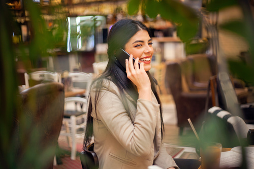 Smiling woman answering the phone Stock Photo