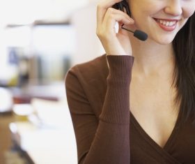 Smiling woman wearing headset Stock Photo