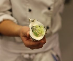 Steamed oysters in the hands of the chef Stock Photo