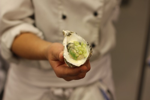 Steamed oysters in the hands of the chef Stock Photo
