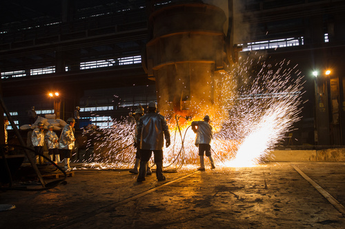 Steelmaking plant and steel workers Stock Photo