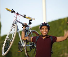 Strong man lifts a bike Stock Photo