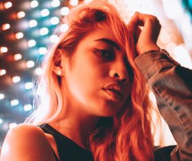 Stylish girl posing under lights Stock Photo