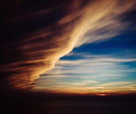 Thick cloudscape on sky at dusk Stock Photo