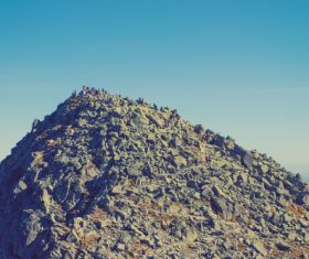 Tourist climbing gravel hill Stock Photo