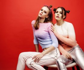 Two fashion hairstyle girls taking pictures in the studio Stock Photo 02