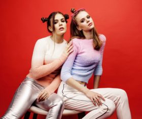 Two fashion hairstyle girls taking pictures in the studio Stock Photo 03