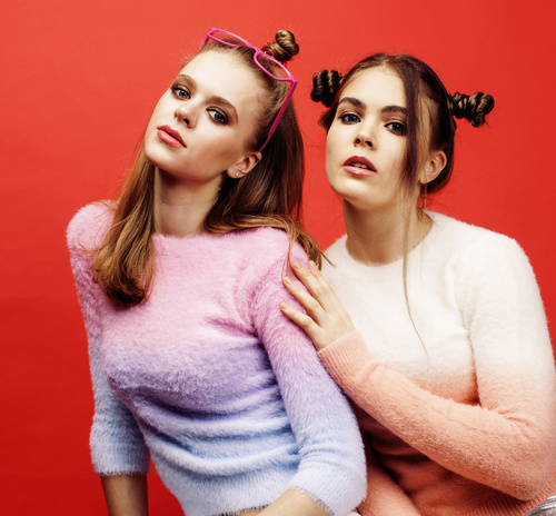 Two fashion hairstyle girls taking pictures in the studio Stock Photo 04