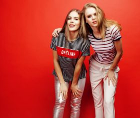 Two girls posing with red background Stock Photo 01