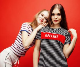 Two girls posing with red background Stock Photo 03