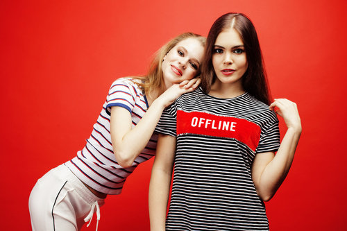 Two girls posing with red background Stock Photo 03