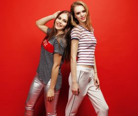 Two girls posing with red background Stock Photo 05