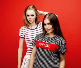 Two girls posing with red background Stock Photo 06