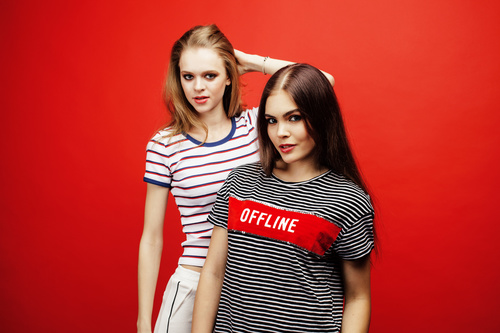 Two girls posing with red background Stock Photo 06