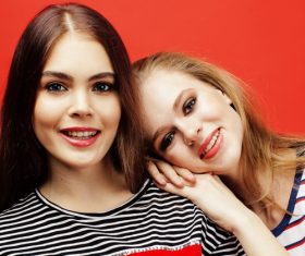 Two girls posing with red background Stock Photo 07