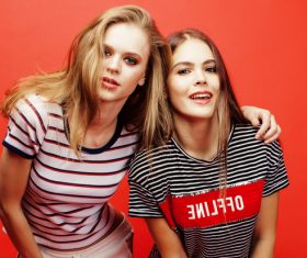 Two girls posing with red background Stock Photo 08