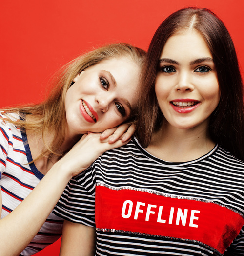 Two girls posing with red background Stock Photo 09
