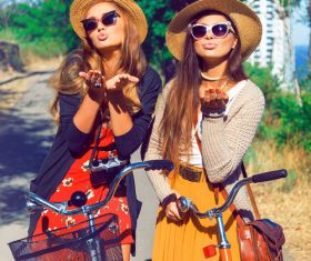 Two girls riding bicycle outing Stock Photo