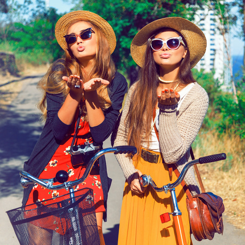 Two girls riding bicycle outing Stock Photo