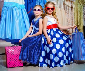 Two little girls sitting in the mall resting Stock Photo