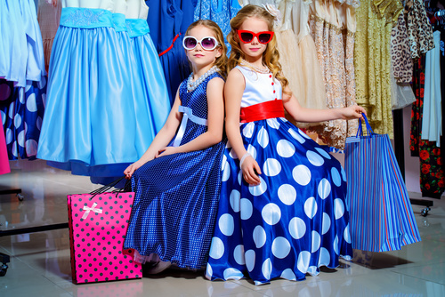 Two little girls sitting in the mall resting Stock Photo