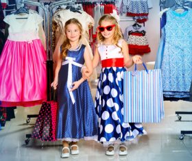 Two stylishly dressed little girls in the mall Stock Photo